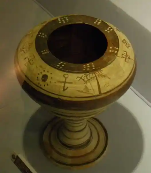 Vase with narrow bottom with solar symbols on the mouth, located at Archaeological Museum of Izmir, Turkey.